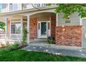 Welcoming front porch with brick accents and ample natural light creates a cozy entry at 5625 W 109Th Cir, Westminster, CO 80020