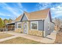 Cozy single-story residence with a stone foundation, matching siding, and a practical carport on a sunny day at 3368 W Gill Pl, Denver, CO 80219