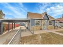 Inviting single-story home with a carport, showcasing a blend of stone and siding for a classic look at 3368 W Gill Pl, Denver, CO 80219