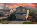Two-story home with a two-car garage, framed by a beautiful sunset sky at 11836 Columbine St, Thornton, CO 80233
