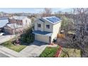 Stylish two-story home with solar panels, a two-car garage, a manicured lawn and mature trees in a quiet neighborhood at 11836 Columbine St, Thornton, CO 80233