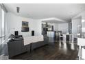 Bright living room featuring hardwood floors, modern furnishings, and large windows at 55 W 12Th Ave # 211, Denver, CO 80204