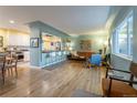 Open concept living room featuring hardwood floors and ample seating at 4891 Depew St, Denver, CO 80212