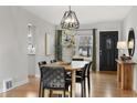 Dining room with modern light fixture, hardwood floors, and black accents at 1876 S Adams St, Denver, CO 80210