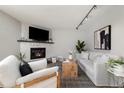 Cozy living room featuring a fireplace, modern furnishings and decor at 1876 S Adams St, Denver, CO 80210