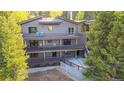 Multi-level deck and patio area overlooking a serene backyard with mature trees, ideal for outdoor living at 537 Moonstone Rd, Breckenridge, CO 80424