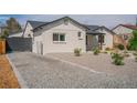 A home with a gravel driveway and low shrubbery next to the side of the house at 6935 W 16Th Ave, Lakewood, CO 80214
