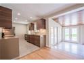 Open-concept kitchen flowing into a sun room, featuring modern appliances and sleek design at 6935 W 16Th Ave, Lakewood, CO 80214