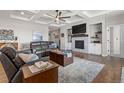 Cozy living room with coffered ceilings, fireplace, built-ins, and hardwood floors at 5035 Old Ranch Dr, Longmont, CO 80503