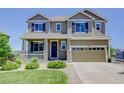 Inviting two-story home featuring a charming front porch, stone accents, and a two-car garage at 5528 Echo Hollow St, Castle Rock, CO 80104