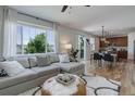 Open-concept living room with hardwood floors, and a view of the dining area and backyard at 5528 Echo Hollow St, Castle Rock, CO 80104