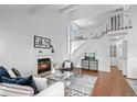 Living room featuring a fireplace, high ceilings, and a staircase leading to the upper level at 1248 W 135Th Ave, Denver, CO 80234