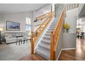 Bright foyer with a staircase, hardwood floors, and views into the living room at 8533 S Flower Ct, Littleton, CO 80128