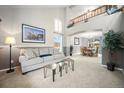 Inviting living room featuring a comfortable sofa and an adjacent dining area at 8533 S Flower Ct, Littleton, CO 80128