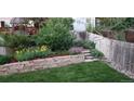 Picturesque backyard featuring stone terracing, lush greenery, and a tranquil garden area, perfect for relaxation at 5126 S Malaya Way, Centennial, CO 80015