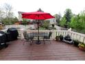 Outdoor deck area featuring a table with an umbrella, grill, and water feature, ideal for entertaining at 5126 S Malaya Way, Centennial, CO 80015