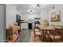 Stylish eat-in kitchen features white cabinets, stone countertops, and modern black appliances at 8843 Colorado Blvd # 208, Thornton, CO 80229