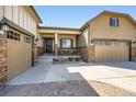 Inviting front porch with stone accents and charming details, complemented by a three-car garage at 3981 Old Oaks St, Castle Rock, CO 80104