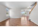 Spacious living room with ample natural light and staircase access at 9638 Marion Way, Thornton, CO 80229