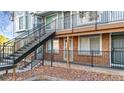 A townhouse exterior featuring brick accents, black iron railings and steps leading to upper units at 185 S Sable Blvd # T18, Aurora, CO 80012