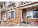 Brick townhouse entrance with a small rock garden and well-maintained walkway at 185 S Sable Blvd # T18, Aurora, CO 80012