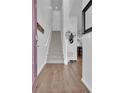 Inviting home entryway featuring hardwood floors and a staircase leading to the upper level at 18938 E 64Th Pl, Denver, CO 80249