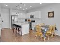 Bright kitchen with stainless steel appliances, granite countertops, and an island with bar seating at 18938 E 64Th Pl, Denver, CO 80249
