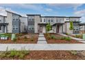 Attractive townhome showcasing contemporary architectural design, new landscaping, and a welcoming entrance at 20520 E 58Th Ave, Aurora, CO 80019