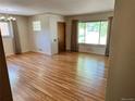 Inviting living room with hardwood floors, large window and plenty of natural light at 2124 S Yates St, Denver, CO 80219