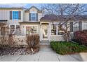 Charming townhome exterior featuring a manicured lawn and walkway at 897 S Granby Cir, Aurora, CO 80012