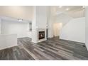 Spacious living room with fireplace and high ceilings, featuring wood-look flooring at 897 S Granby Cir, Aurora, CO 80012