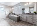 Serene bathroom with soaking tub, dual vanities, and modern fixtures at 211 Luna Ct, Erie, CO 80516