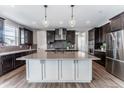 Modern kitchen featuring a large island, stainless steel appliances, and pendant lighting at 211 Luna Ct, Erie, CO 80516