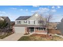 Beautiful two-story home with solar panels and a well-maintained front yard, offering comfort and curb appeal at 9957 Candlewood Ln, Highlands Ranch, CO 80126