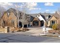 Luxury home with stone exterior, landscaping, and a large driveway at 1312 Jade Ln, Longmont, CO 80504