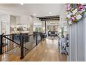 Grand foyer with hardwood floors, iron railing staircase, and open access to the main living area at 878 Tree Bark Ter, Colorado Springs, CO 80132
