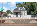 Charming two-story home on a tree-lined street with manicured front yard at 1076 Mariposa St, Denver, CO 80204