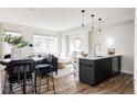 Inviting living area featuring a modern kitchen, dining space, and cozy seating area at 1206 S Reed St, Lakewood, CO 80232