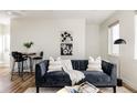 Cozy living room with a comfortable sofa, decorative pillows, and elegant wall art at 1206 S Reed St, Lakewood, CO 80232