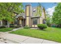 Charming home with a well-manicured lawn and neutral-colored facade with stone and brown accents at 18538 E Whitaker Cir # A, Aurora, CO 80015
