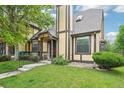 Charming home with a well-manicured lawn and neutral-colored facade with stone and brown accents at 18538 E Whitaker Cir # A, Aurora, CO 80015