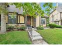 Charming home with a well-manicured lawn and neutral-colored facade with stone and brown accents at 18538 E Whitaker Cir # A, Aurora, CO 80015