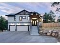 Impressive home with a grand entrance, stone accents, and a well-maintained driveway at 24701 Us Hwy 40, Golden, CO 80401