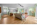 Open-concept living room featuring hardwood floors, a fireplace, and lots of natural light at 8205 Pennsylvania St, Denver, CO 80229