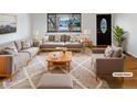 Bright living room with neutral decor, large window, and stylish furnishings at 13477 E Center Ave, Aurora, CO 80012