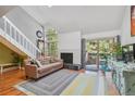 Living room view with vaulted ceilings, fireplace, and balcony access at 701 Harlan St # E29, Lakewood, CO 80214