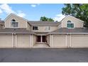 Traditional townhome featuring private garages, neutral exterior, and a well-maintained community at 7476 E Arkansas Ave # 1-03, Denver, CO 80231