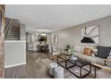 Open concept living room and dining area with hardwood floors at 7476 E Arkansas Ave # 1-03, Denver, CO 80231