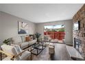 Bright living room with hardwood floors and stone fireplace at 7476 E Arkansas Ave # 1-03, Denver, CO 80231