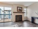 Cozy fireplace with a modern mantel and glass doors at 1312 S Cathay Ct # 202, Aurora, CO 80017